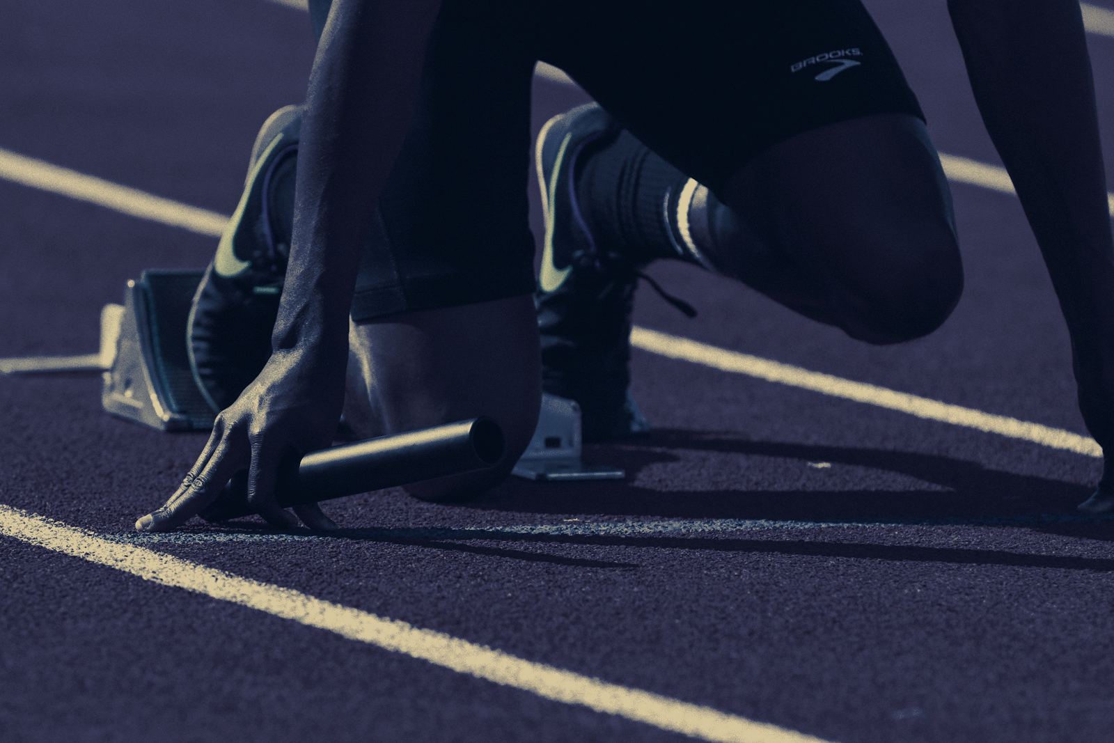 Athlete in starting blocks on a track